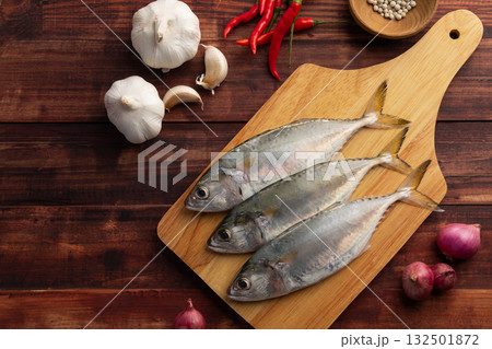 Raw fresh mackerel fish (short bodied mackerel ) on cutting board.Fresh seafood ingredients.Top view copy space. 132501872