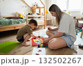 Mother and child engaged in creative painting activity at home 132502267