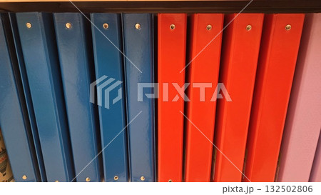 Colorful organization with blue and orange ring binders for office and school supplies. Horizontal banner. Copy space. Back to school Colorful organization with blue and orange ring binders for office and school supplies. Horizontal banner. Copy space. Back to school 132502806