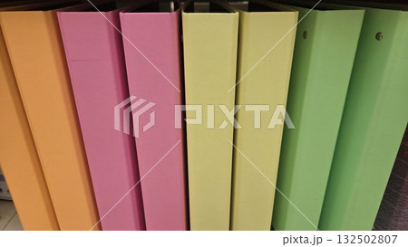 Vibrant array of colorful office binders for organization and classroom essentials. Horizontal banner. Copy space. Back to school Vibrant array of colorful office binders for organization and classroom essentials. Horizontal banner. Copy space. Back to school 132502807