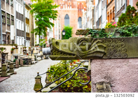 Captivating view of intricate wrought iron railings set against the historic red brick buildings in Gdansk Old Town. The architectural detail reflects the city's rich history 132503092