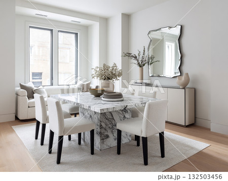 A chic, minimalist dining room featuring a round concrete table, white boucle chairs, an arched mirror, and dried floral arrangements against a neutral wall. A chic, minimalist dining room featuring a round concrete table, white boucle chairs, an arched mirror, and dried floral arrangements against a neutral wall. 132503456