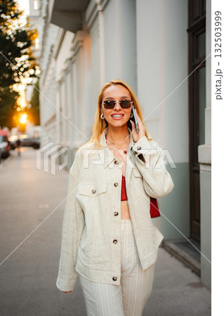 Woman talking on phone walking in Vienna street 132503999