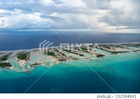 Aerial view of Rangiroa atoll, French Polynesia, with lagoon and cloudy sky Aerial view of Rangiroa atoll, French Polynesia, with lagoon and cloudy sky 132504041