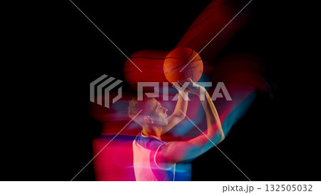 Basketball player raising ball to shoot with dynamic red and blue light streaks 132505032