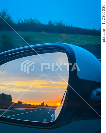 Sunset view in the car mirror. Sunset view in the car mirror. 132505036