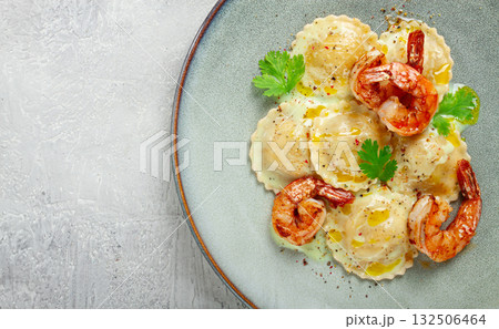 ravioli with shrimp, in cream sauce, with spices and herbs, top view, no people, 132506464
