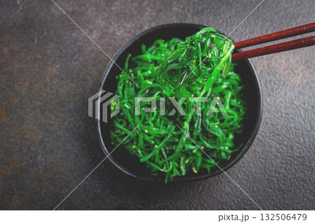 Chuka salad, made from fresh seaweed, with sesame dressing, served in a black bowl, with chopsticks, Chuka salad, made from fresh seaweed, with sesame dressing, served in a black bowl, with chopsticks, 132506479
