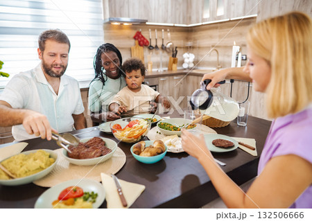 Family sharing a homemade meal at the table 132506666