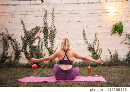 Empowered mother practicing exercises in a tranquil outdoor space post-birth Empowered mother practicing exercises in a tranquil outdoor space post-birth 132506858