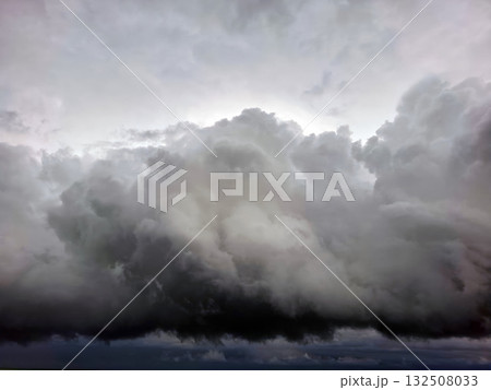 Low, thick thunderclouds loom in the sky, signaling the arrival of Hurricane Storm Dana. The atmosphere is tense and foreboding as the storm prepares to unleash its power. Low, thick thunderclouds loom in the sky, signaling the arrival of Hurricane Storm Dana. The atmosphere is tense and foreboding as the storm prepares to unleash its power. 132508033