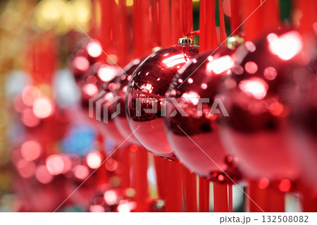 big Christmas balls hanging on red ribbons 132508082