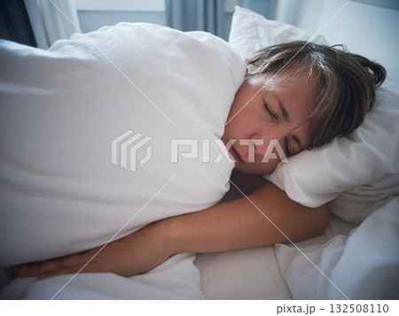 Lonely 35 year old woman sleeping alone after breakup, sadness and emotional emptiness Lonely 35 year old woman sleeping alone after breakup, sadness and emotional emptiness 132508110