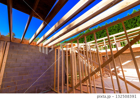 Workers are constructing new wooden frames at building site construction rafters structure beams framework 132508391