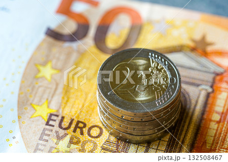 Stack of two euro coins on fifty euro banknote symbolizing European finance, money, and economy Stack of two euro coins on fifty euro banknote symbolizing European finance, money, and economy 132508467