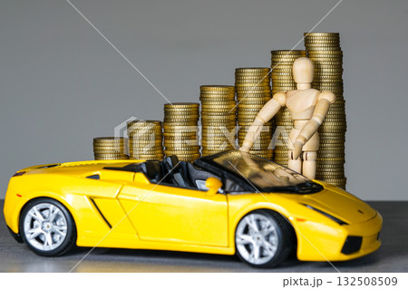 Wooden mannequin with stacks of gold coins and yellow sports car symbolizing wealth and success Wooden mannequin with stacks of gold coins and yellow sports car symbolizing wealth and success 132508509