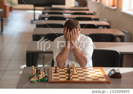 Middle aged Caucasian man playing chess.  132509405