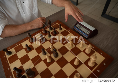 A man switches a chess clock.  132509412