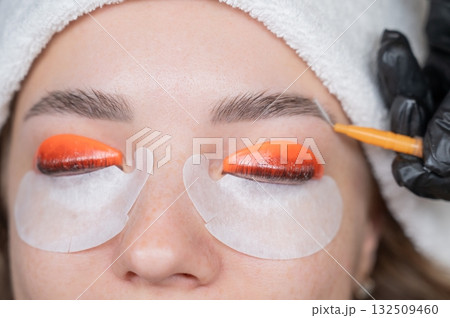 Caucasian woman undergoing eyelash lamination procedure.  132509460