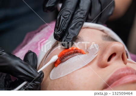Caucasian woman undergoing eyelash lamination procedure. Caucasian woman undergoing eyelash lamination procedure. 132509464
