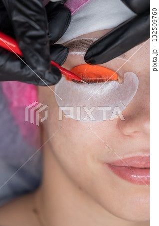 Caucasian woman undergoing eyelash lamination procedure. Caucasian woman undergoing eyelash lamination procedure. 132509760