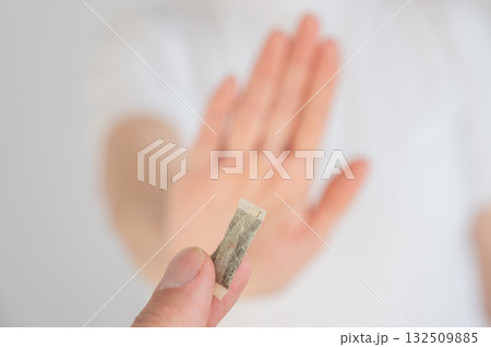 The woman refuses to take chewing tobacco.  132509885