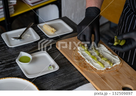 The cook prepares a fruit roll from pancakes.  132509897