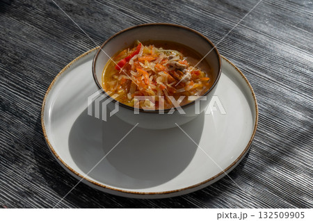 A bowl of shchi soup in a cafe.  132509905