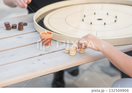 Strategic Game Pieces on a Wooden Board crokinole. Strategic Game Pieces on a Wooden Board crokinole. 132509908