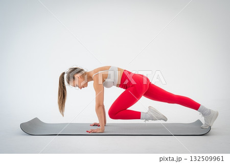 Young woman doing plank exercise on white background. Young woman doing plank exercise on white background. 132509961