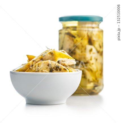 Pickled artichoke in bowl isolated on white background. 132510006
