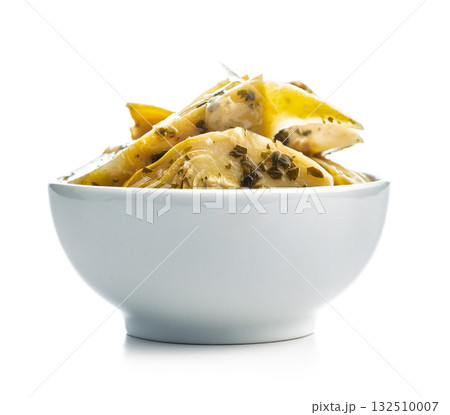 Pickled artichoke in bowl isolated on white background. 132510007