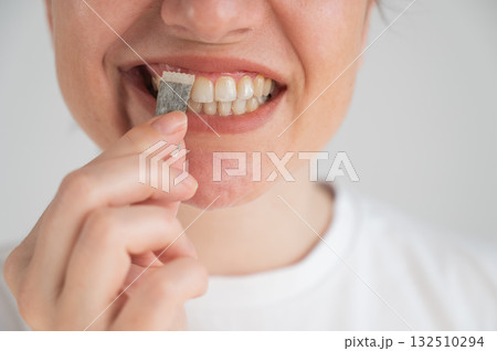 A woman uses chewing tobacco.  132510294