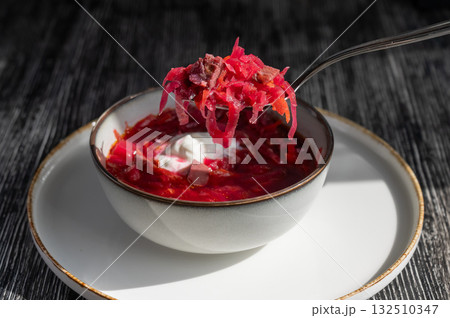 A bowl of borscht soup in a cafe. A bowl of borscht soup in a cafe. 132510347