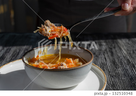 A bowl of shchi soup in a cafe. A bowl of shchi soup in a cafe. 132510348
