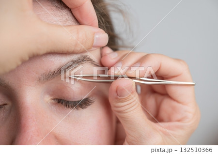 Caucasian woman undergoing eyebrow correction procedure.  132510366