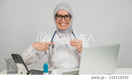 Female doctor in hijab recommends medications.  132510392