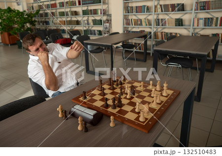 Caucasian man celebrates winning chess. Caucasian man celebrates winning chess. 132510483