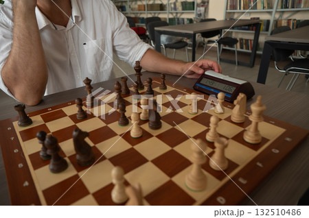 A man switches a chess clock. A man switches a chess clock. 132510486