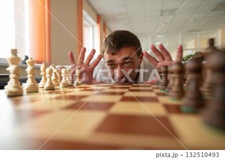 Middle aged Caucasian man playing chess. Middle aged Caucasian man playing chess. 132510493