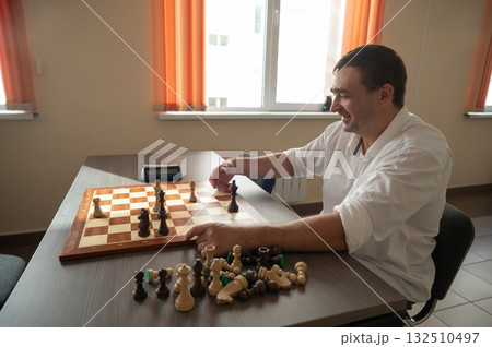 Middle aged Caucasian man playing chess. Middle aged Caucasian man playing chess. 132510497