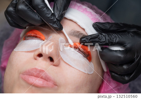 Caucasian woman undergoing eyelash lamination procedure.  132510560