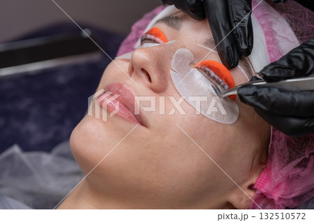 Caucasian woman undergoing eyelash lamination procedure.  132510572
