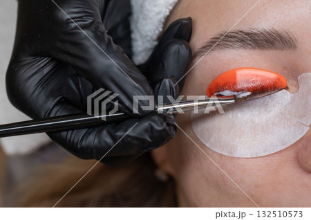 Caucasian woman undergoing eyelash lamination procedure.  132510573