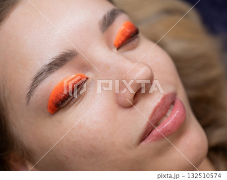 Caucasian woman undergoing eyelash lamination procedure. Caucasian woman undergoing eyelash lamination procedure. 132510574