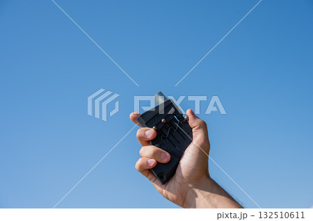 A man fires a flare gun with emergency fire. Close-up of a man's hand.  132510611