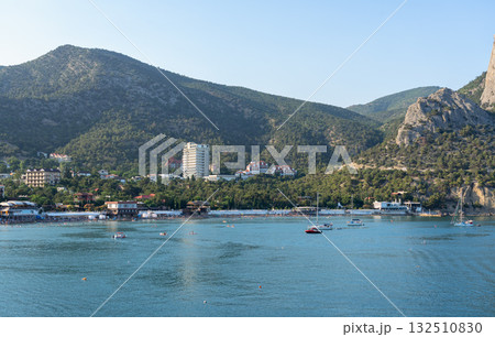 Crimean coast, Mount Sokol and yachts in the Novy Svet bay at sunrise Crimean coast, Mount Sokol and yachts in the Novy Svet bay at sunrise 132510830