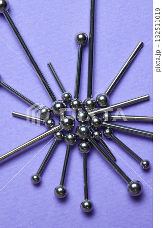 Piercing earrings close-up. On a Violet background. Piercing earrings close-up. On a Violet background. 132511019