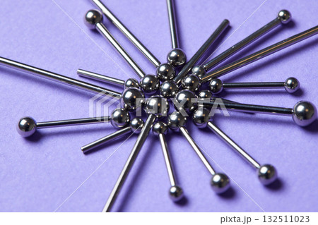 Piercing earrings close-up. On a Violet background. Piercing earrings close-up. On a Violet background. 132511023