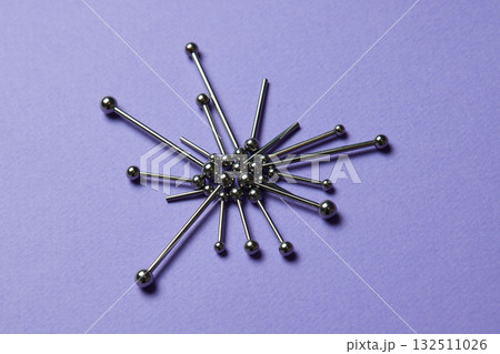 Piercing earrings close-up. On a Violet background. 132511026